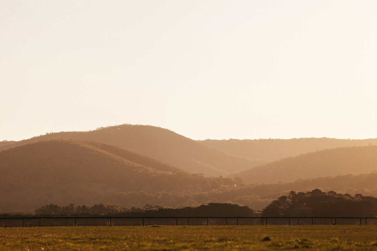 Sunset over the Macedon Ranges near Deep Creek, showing natural volcanic hills and native forest.