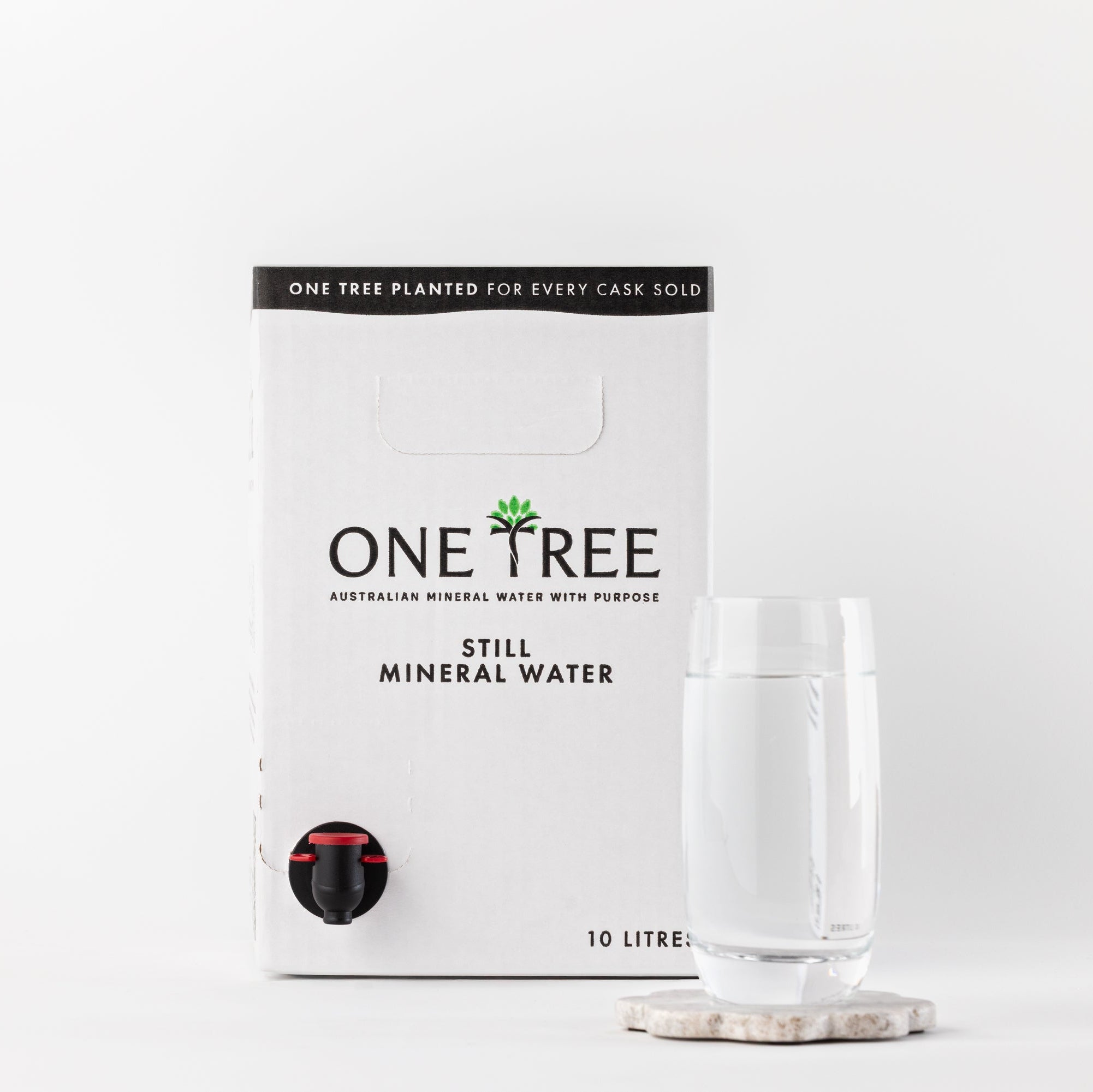 Front view of One Tree Still Mineral Water 10L cask with a glass of pure mineral water.